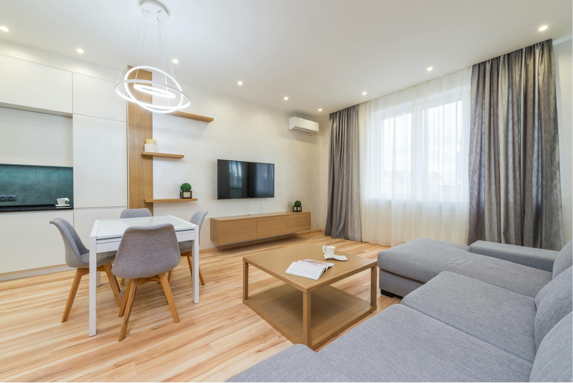 a living room with couch, chairs, and tables